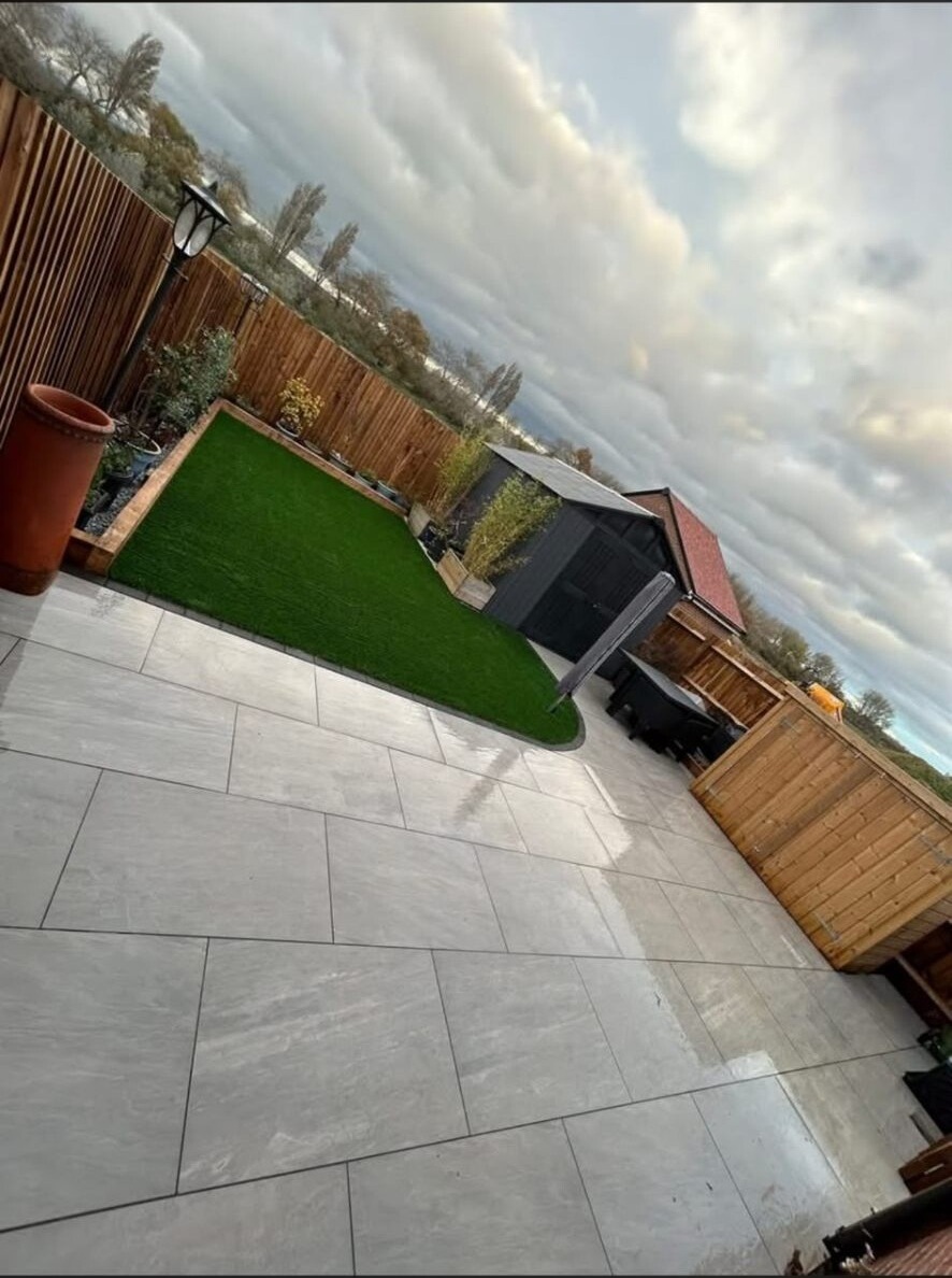 Sandstone patio alongside a flower border at a West Sussex property.